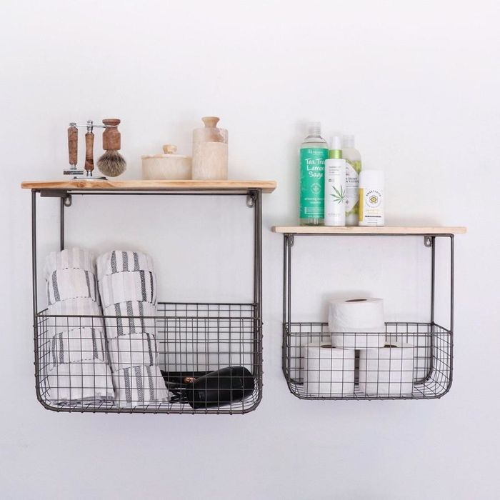 two floating shelves, each featuring a wire basket underneath