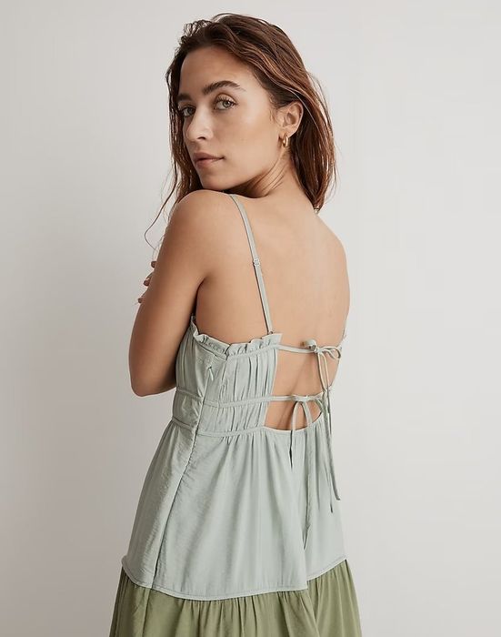 Back view of the same model, highlighting the tie-back detail of the dress.