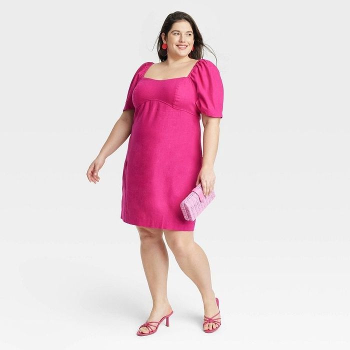 A model wearing a hot pink puff sleeve dress.