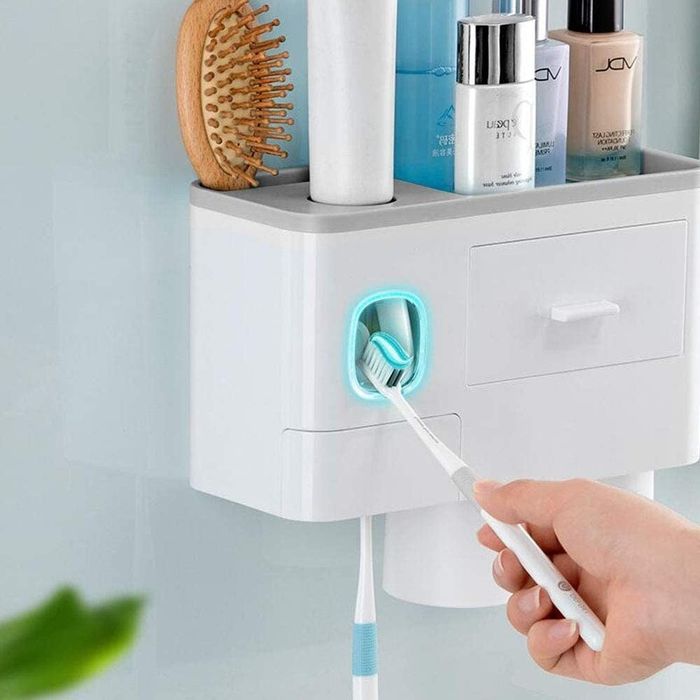 Model using a toothpaste dispenser with a toothbrush