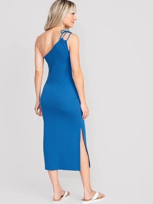 A model wearing the blue one-shoulder dress, captured from the back.