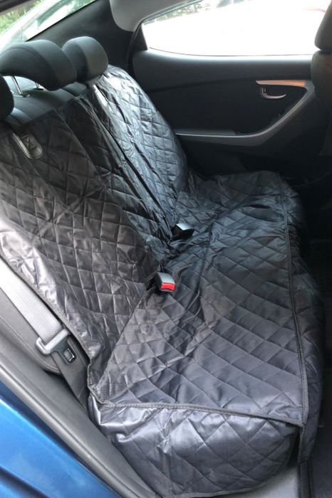 A reviewer's photo of a car's backseat featuring the quilted cover in place.