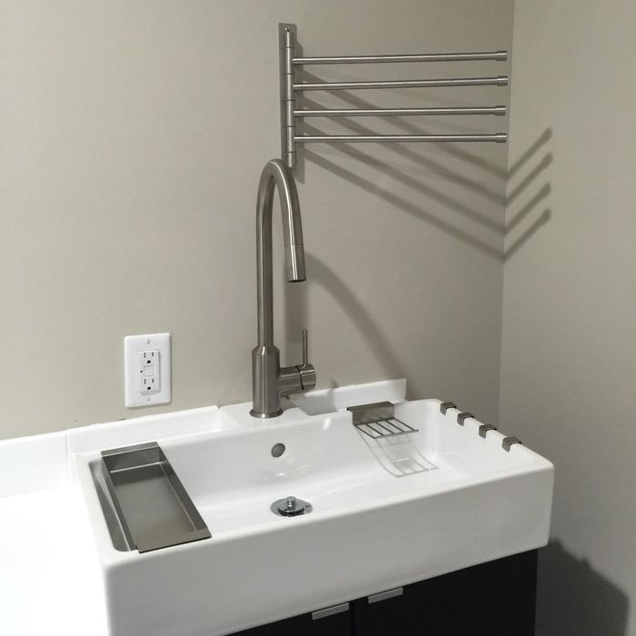 A reviewer's bathroom features a towel rack mounted above the sink.