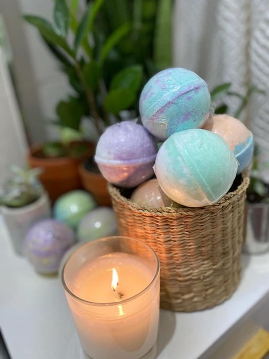 A reviewer's basket filled with vibrant bath bombs.