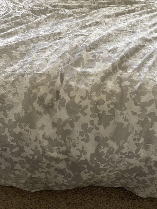 A reviewer's photo of the same comforter, now stain-free after treatment.