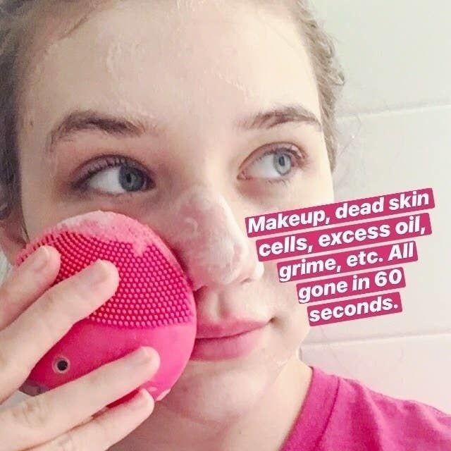 Mytour writer Maitland using the brush to gently massage soap onto her face, showing off its effortless application.