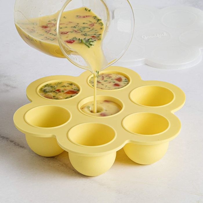 An egg mixture filled with vegetables is being poured into the egg mold, ready to be cooked.