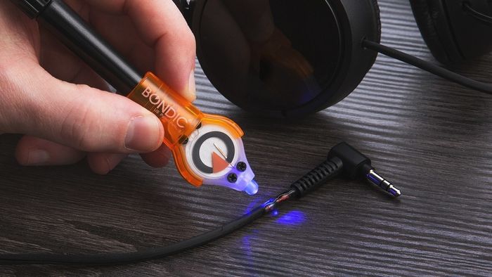 The Bondic LED UV light is being used on a frayed cord to seal and restore it to its original form.