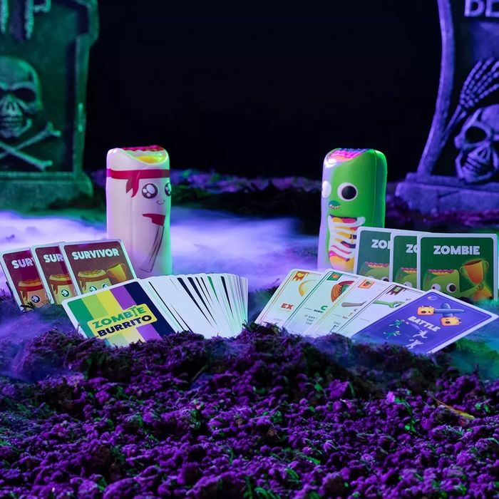 Zombie Burrito card game displayed with spooky graveyard-themed decor, showcasing game pieces and cards ready for a wild, fun-filled showdown.