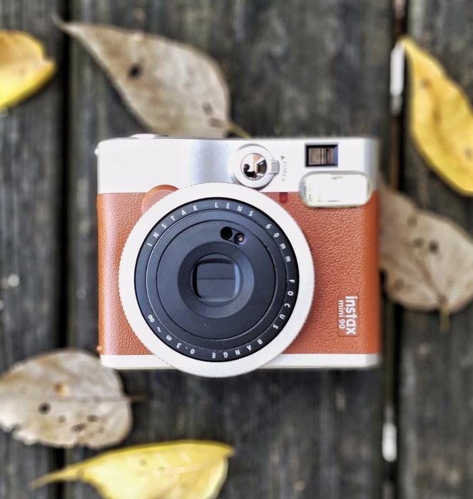 A reviewer image showcasing the camera in a rich brown color