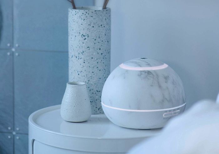 The Hathaspace Marble Essential Oil Aroma Diffuser elegantly placed in a bedroom, filling the air with a calming fragrance.