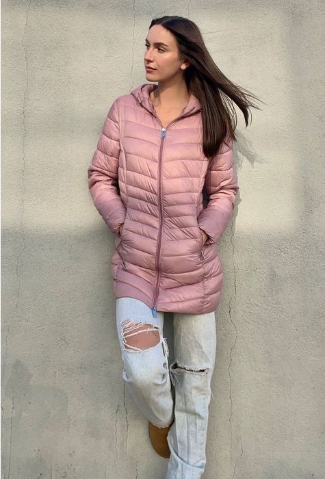 a person wearing a dusty rose slim-fit puffer coat