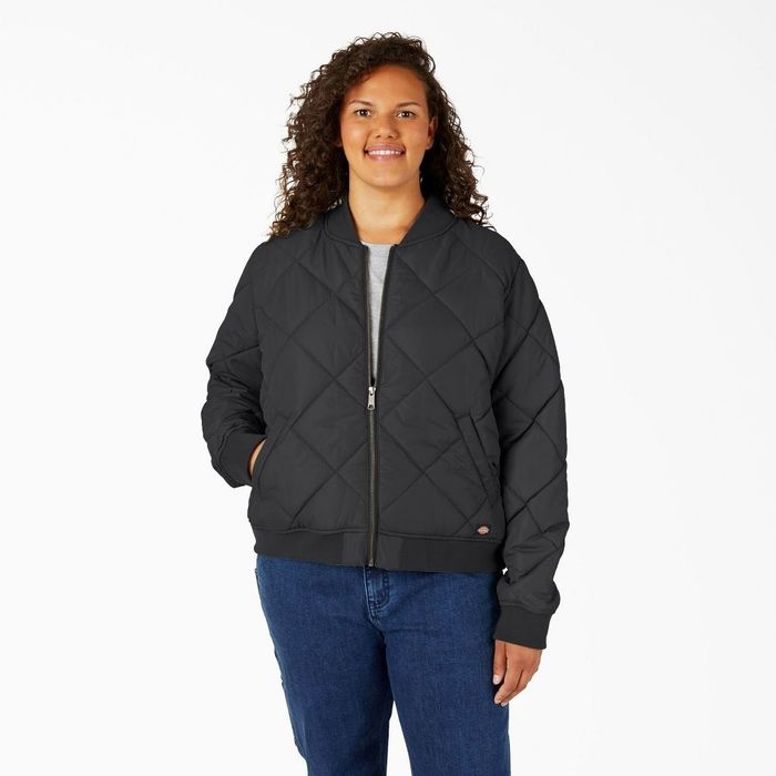 A person wearing a black quilted bomber jacket with a zip-up front.