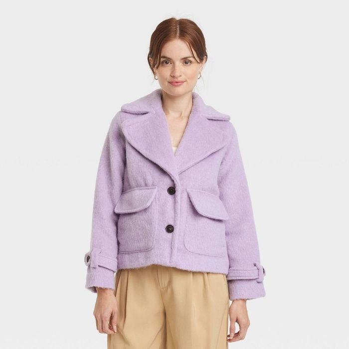 a person wearing a soft lavender utility jacket with large front pockets and a slightly cropped cut
