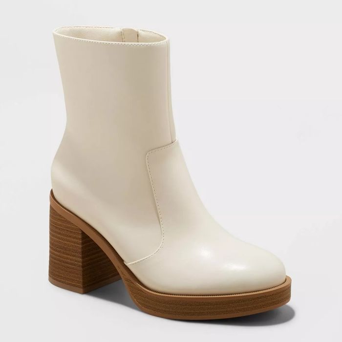 White ankle boots featuring a brown block heel