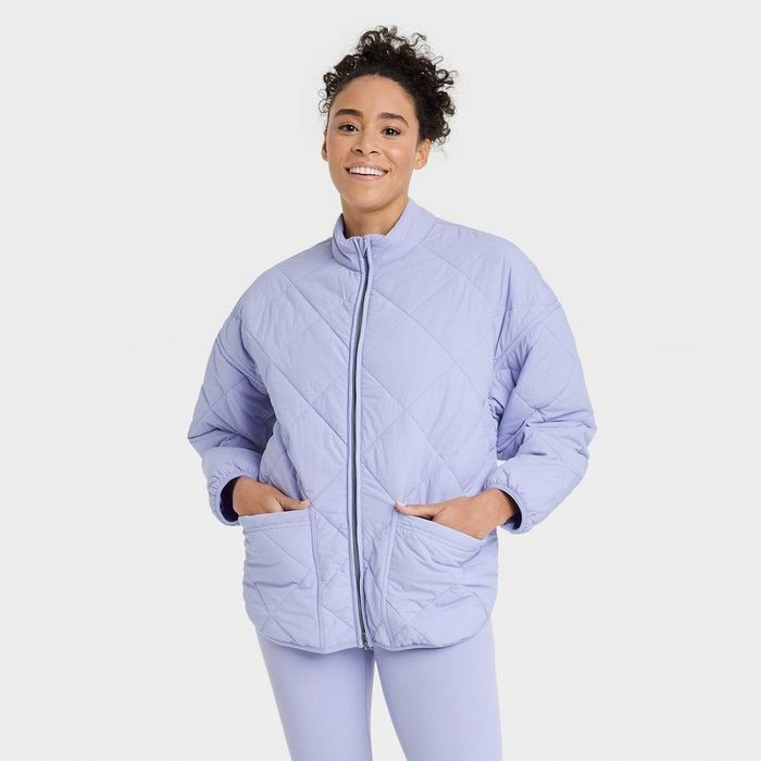 a person wearing a lavender quilted fitted puffer coat