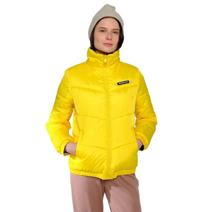 A person is seen wearing a yellow puffer jacket.