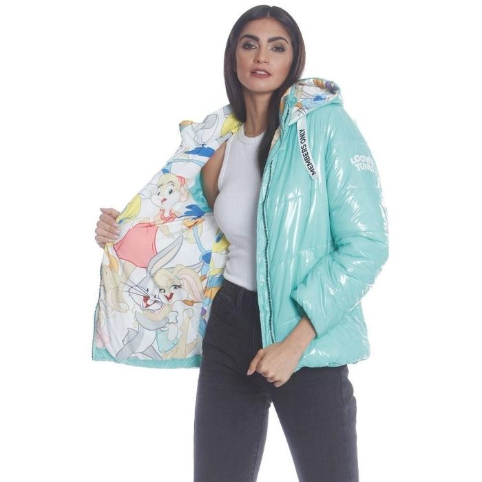 a person sporting a shiny turquoise puffer jacket featuring Looney Tunes characters on the inner lining
