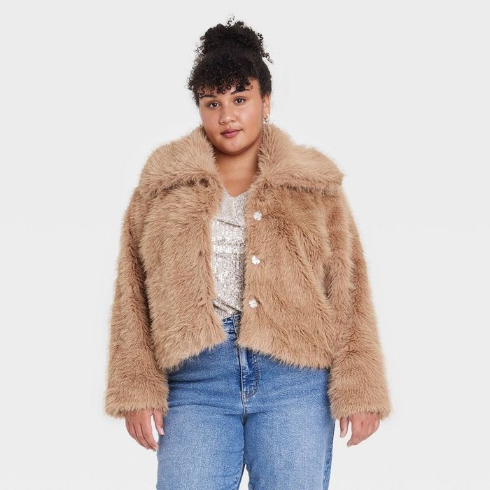 a person dressed in a waist-length shaggy faux fur coat