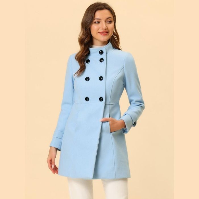 a person wearing a light blue stand collar coat