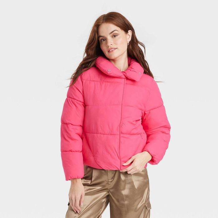 a person wearing a hot pink puffer jacket without a hood
