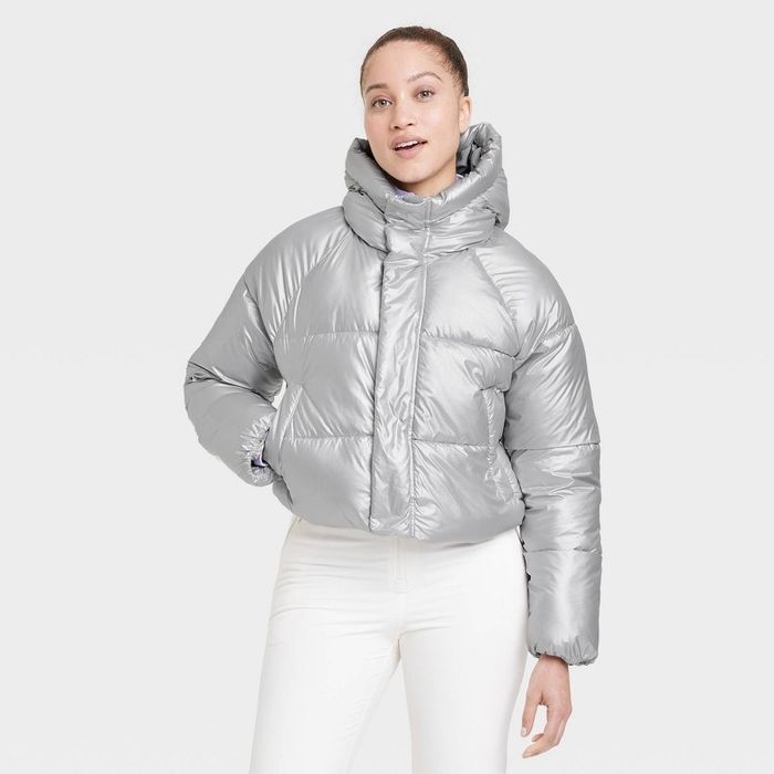 a person rocking a waist-length silver puffer coat