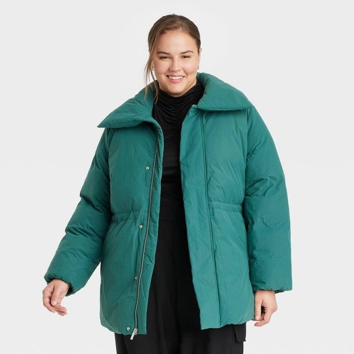 individual dressed in a green puffer coat with a collar