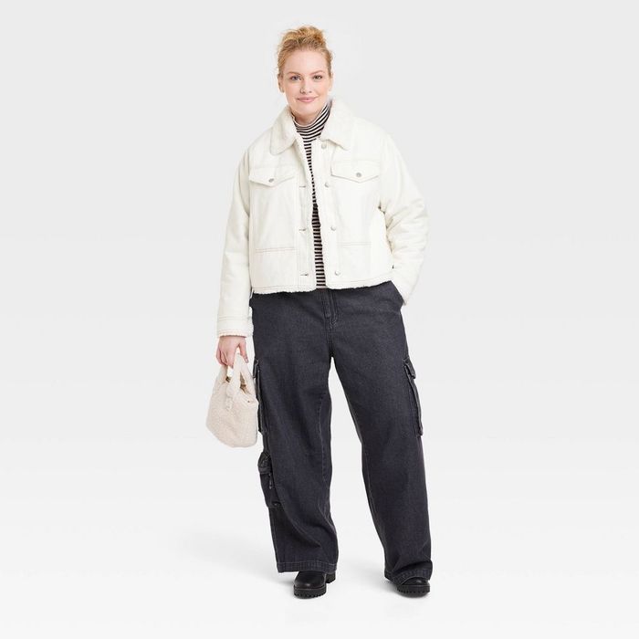 a person wearing a white trucker jacket
