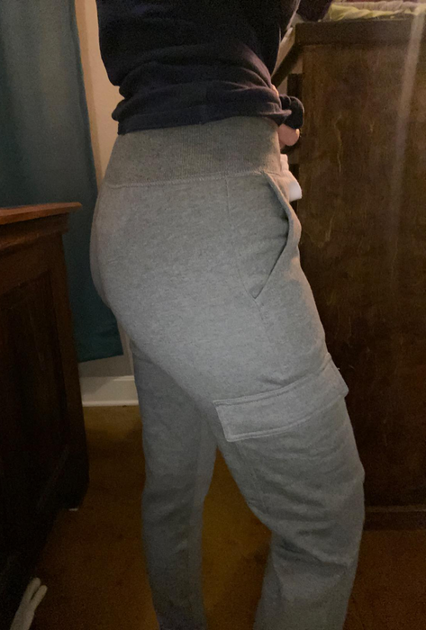 A photo of a reviewer wearing gray pants.