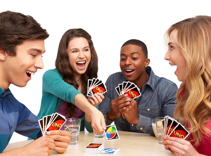 Players using Uno cards to enjoy a fun game.