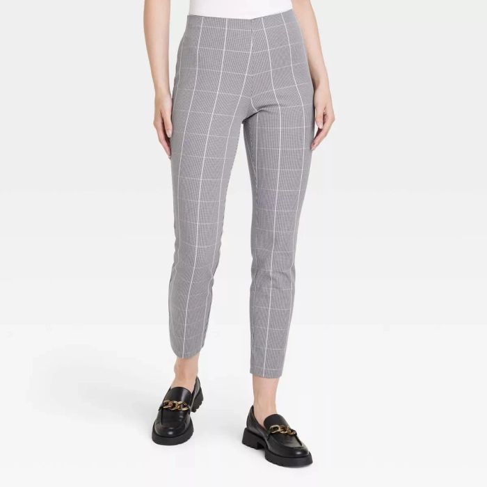 a model showcasing the pants in gray with a white windowpane plaid design