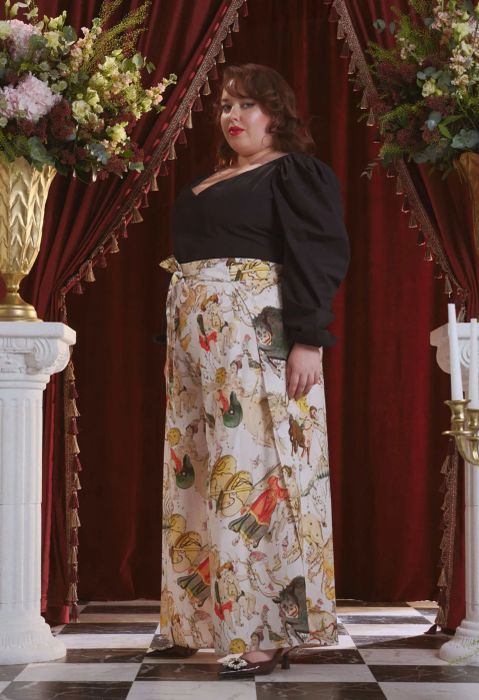 a model wearing white, wide-leg pants with a multicolor Zodiac print with tie at the front waist