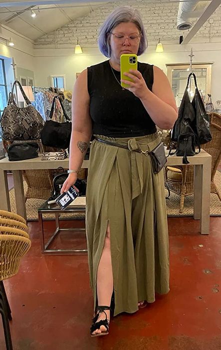 a reviewer showcasing the pants in a khaki green shade