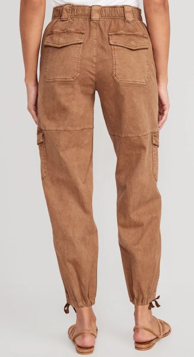 the rear view of the pants in light brown highlighting the elastic waistband
