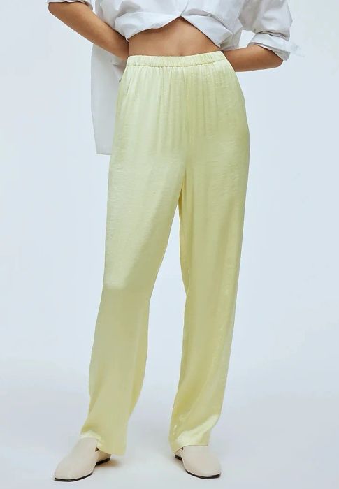 a model showcasing the pants in a vibrant yellowish-green hue, highlighting the comfortable elastic waistband