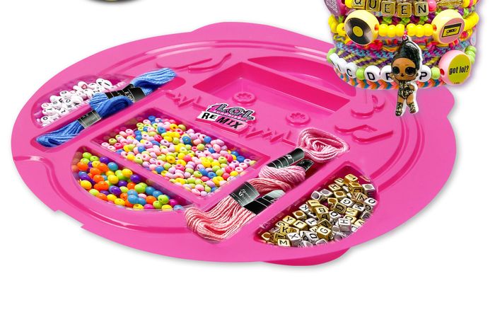 A pink tray filled with a variety of beads, threads, and all the necessary supplies for making jewelry.