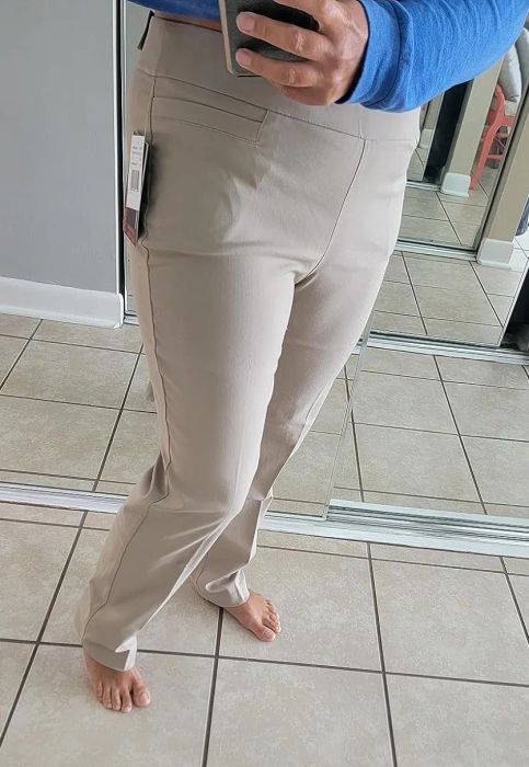 a reviewer modeling the pants in light khaki