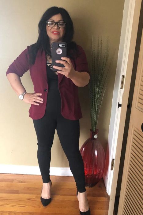 A mirror selfie of a reviewer wearing the leggings styled with heels and a blazer, showcasing their versatility.