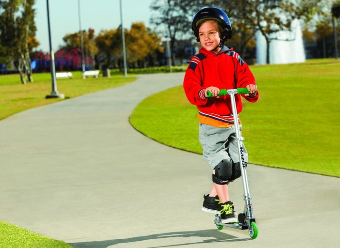 A silver Razor scooter featuring green wheels and handles.