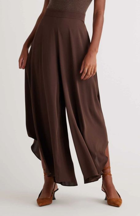 A model elegantly dressed in brown pants, offering a timeless and versatile look.