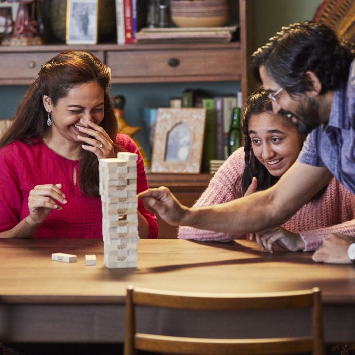 A family enjoying a game of Jenga