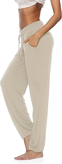 A fashion model showcasing beige-colored pants.