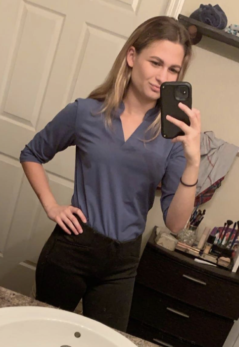 A reviewer wearing the shirt in gray.