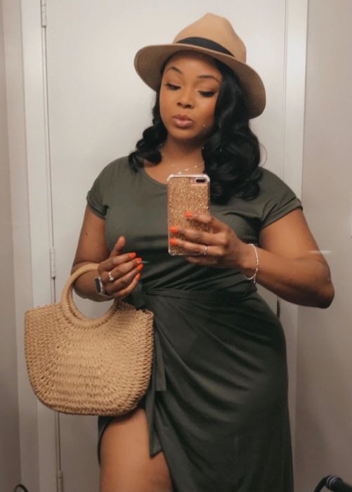 A reviewer showcasing the purse in their hands.