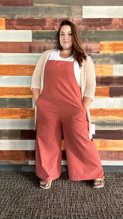 A reviewer sporting coral-colored overalls