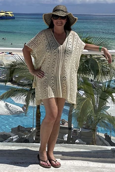 A reviewer wearing a cream-colored cover-up.