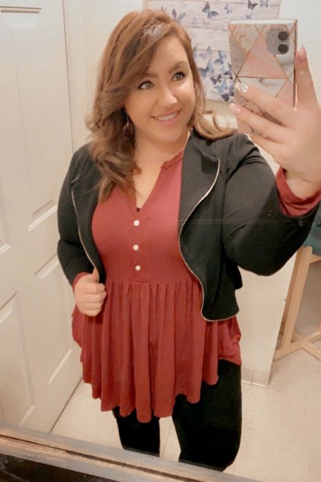 A reviewer wearing the tunic in brown.