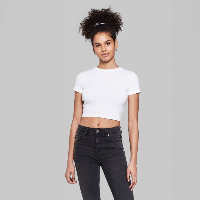 model sporting a white crop tee