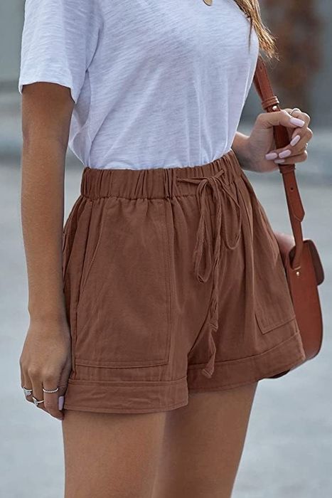 A model showcasing the shorts in brown.