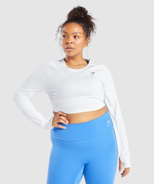 model sporting a white athletic crop top paired with leggings